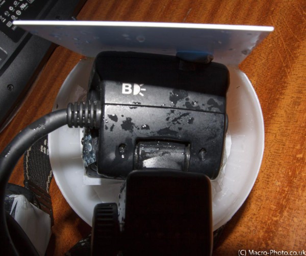 Showing the back of flashgun, bluetacked to the plastic. Showing the back of flashgun, bluetacked to the plastic.
